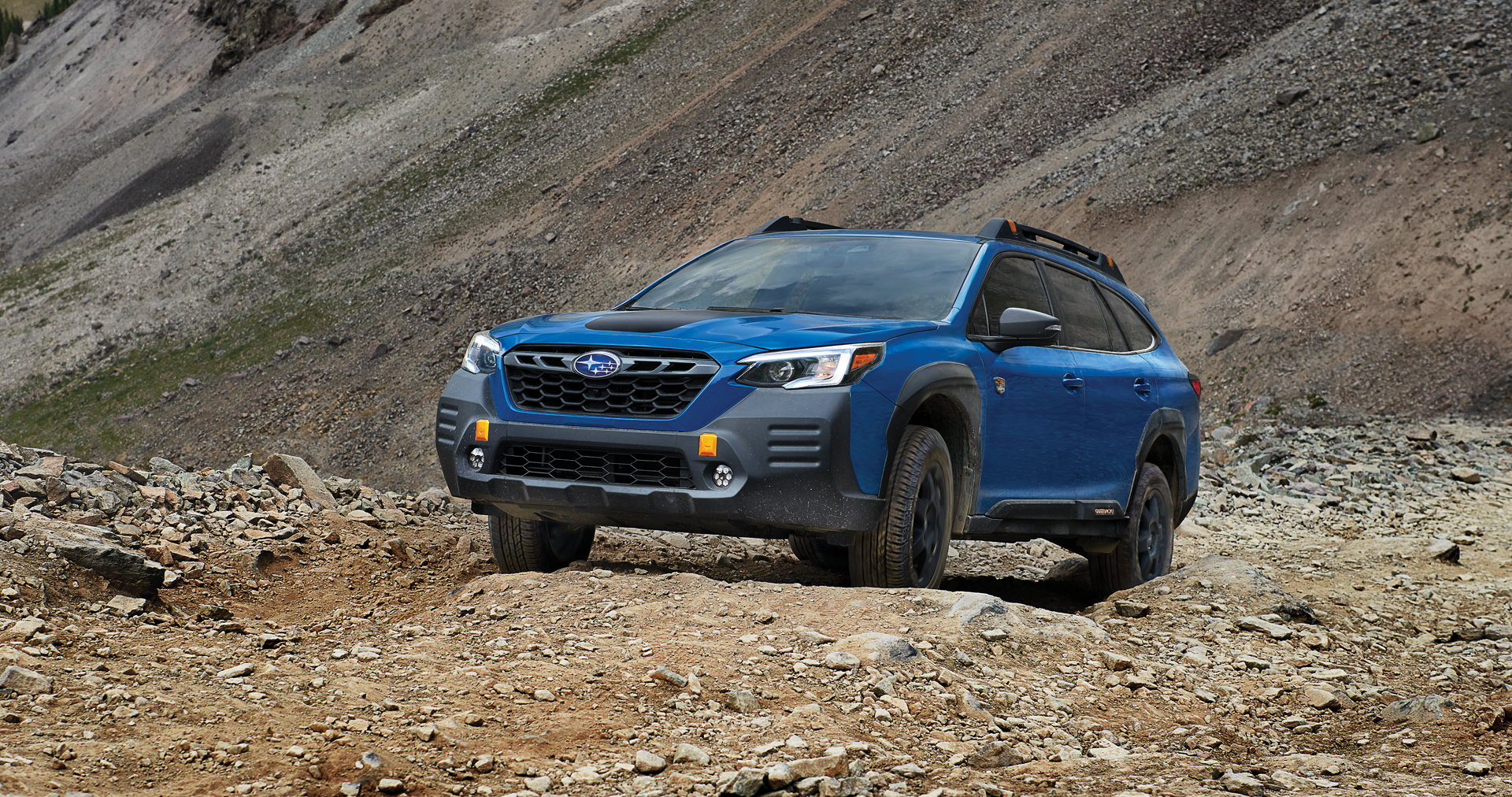 A 2023 Outback Wilderness driving on a trail in the mountains. | Vann York Subaru in Asheboro NC